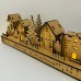 Wooden Christmas light up decoration featuring a village scene with tree and houses. Laser cut wood is hand assembled with LED lights.