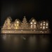 Wooden Christmas light up decoration featuring a village scene with tree and houses. Laser cut wood is hand assembled with LED lights.